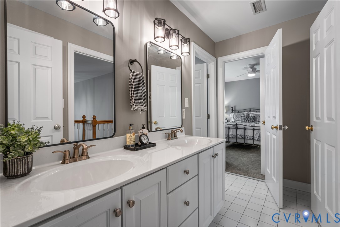 638 Cross Ridge Lane Manakin-Sabot, VA 23103 - Photo 31 of 54 a bathroom with a granite countertop sink a large mirror and a shower