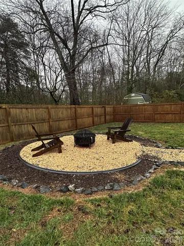 a view of a backyard with large trees