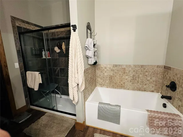 a bathroom with a bathtub and shower
