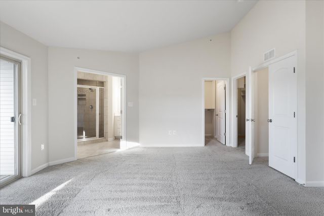 a bathroom with a granite countertop sink a mirror and a shower