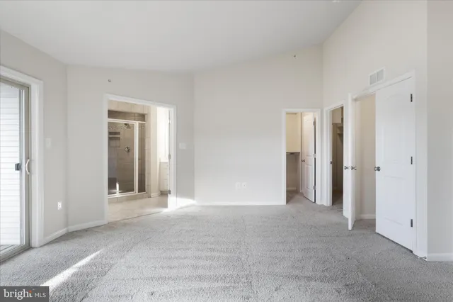 a bathroom with a granite countertop sink a mirror and a shower
