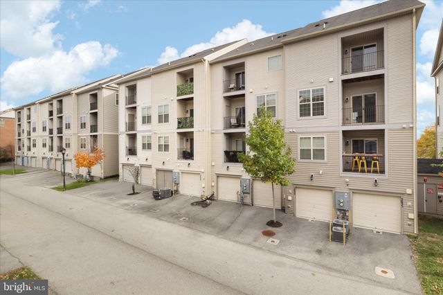 a view of a lake with a table and chairs under an umbrella