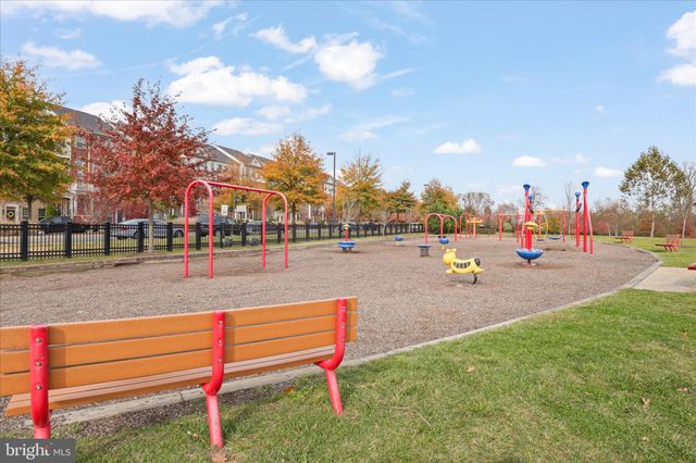 a picture of a bench in front of a wall