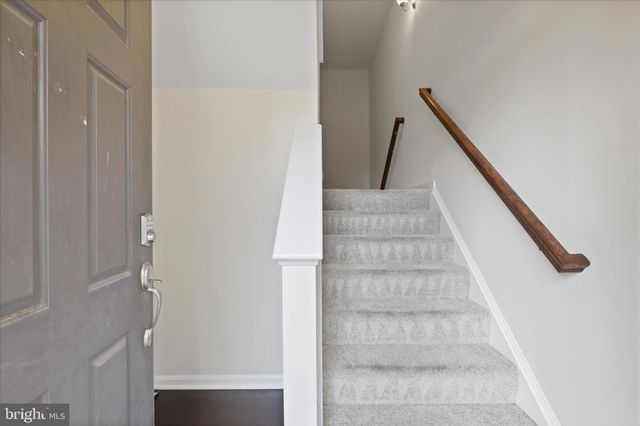 a view of staircase with white walls and stairs