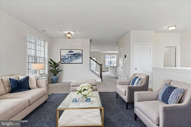 a living room with furniture and white walls