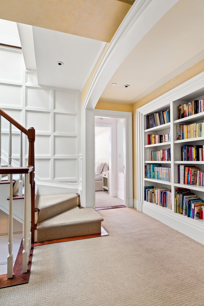 333 East 68th Street, Unit PHC Manhattan, NY 10065 - Photo 12 of 24 a spacious bedroom with a large bed and a book shelf