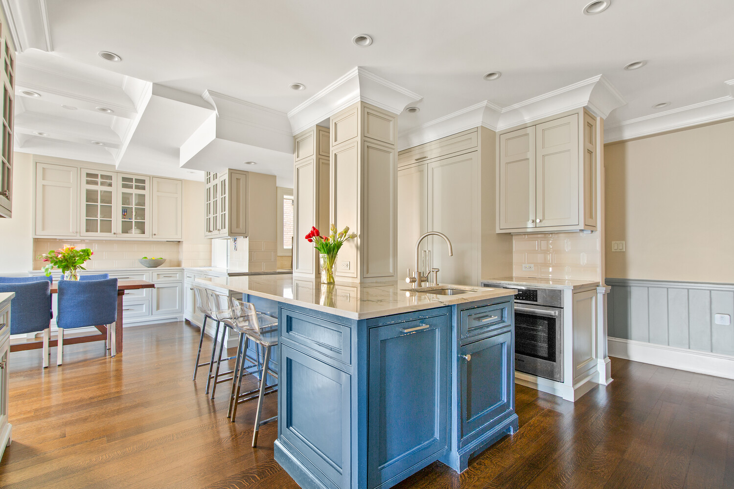 333 East 68th Street, Unit PHC Manhattan, NY 10065 - Photo 4 of 24 a kitchen with stainless steel appliances granite countertop a stove top oven a sink a dining table and chairs