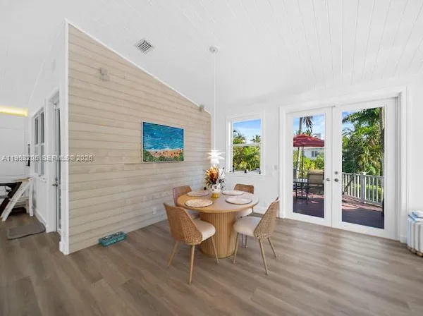 a dining room with furniture and wooden floor