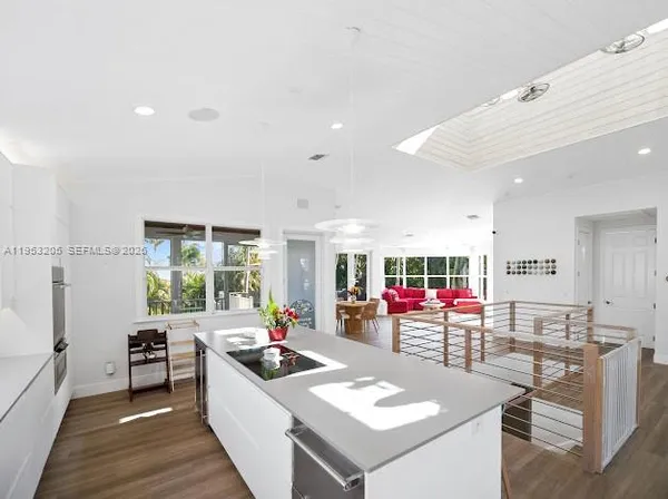 a kitchen with stainless steel appliances kitchen island granite countertop a sink and cabinets