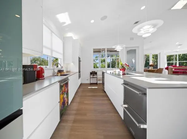 a kitchen with stainless steel appliances a sink stove and cabinets
