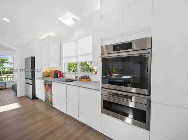 a kitchen with granite countertop a stove and a refrigerator