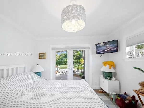 a bedroom with furniture and a window