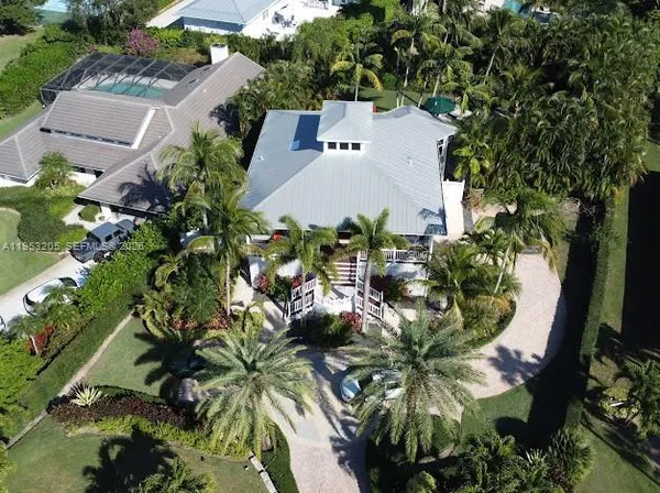 an aerial view of a house with a yard and a garden