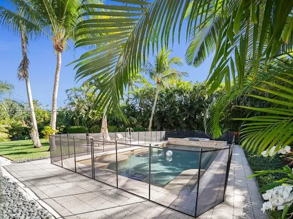 a view of a house with a swimming pool and a big yard