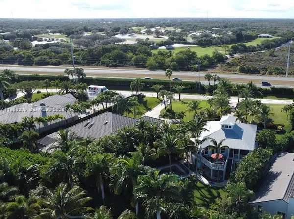 an aerial view of a house with a lake view
