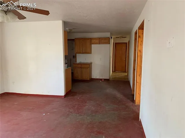 a view of a kitchen with a sink and cabinets