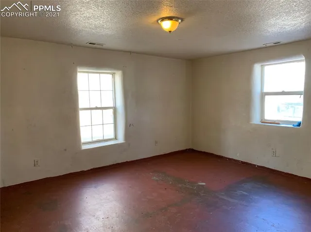 an empty room with a empty space and windows
