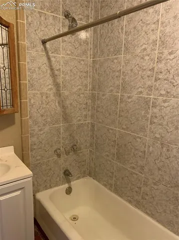 a bathroom with a bathtub and shower
