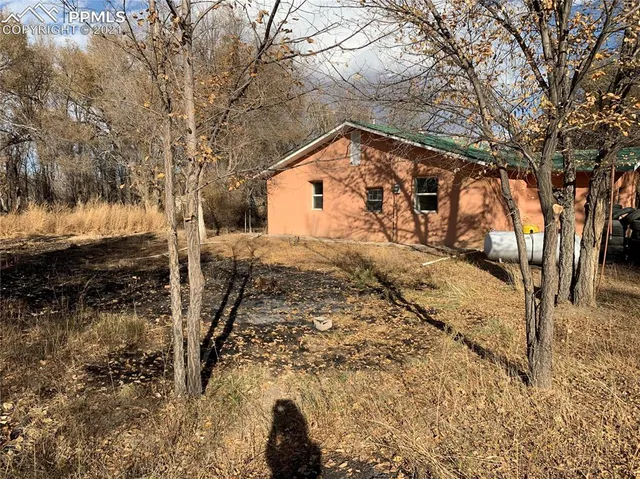 a view of a house with a yard covered with snow