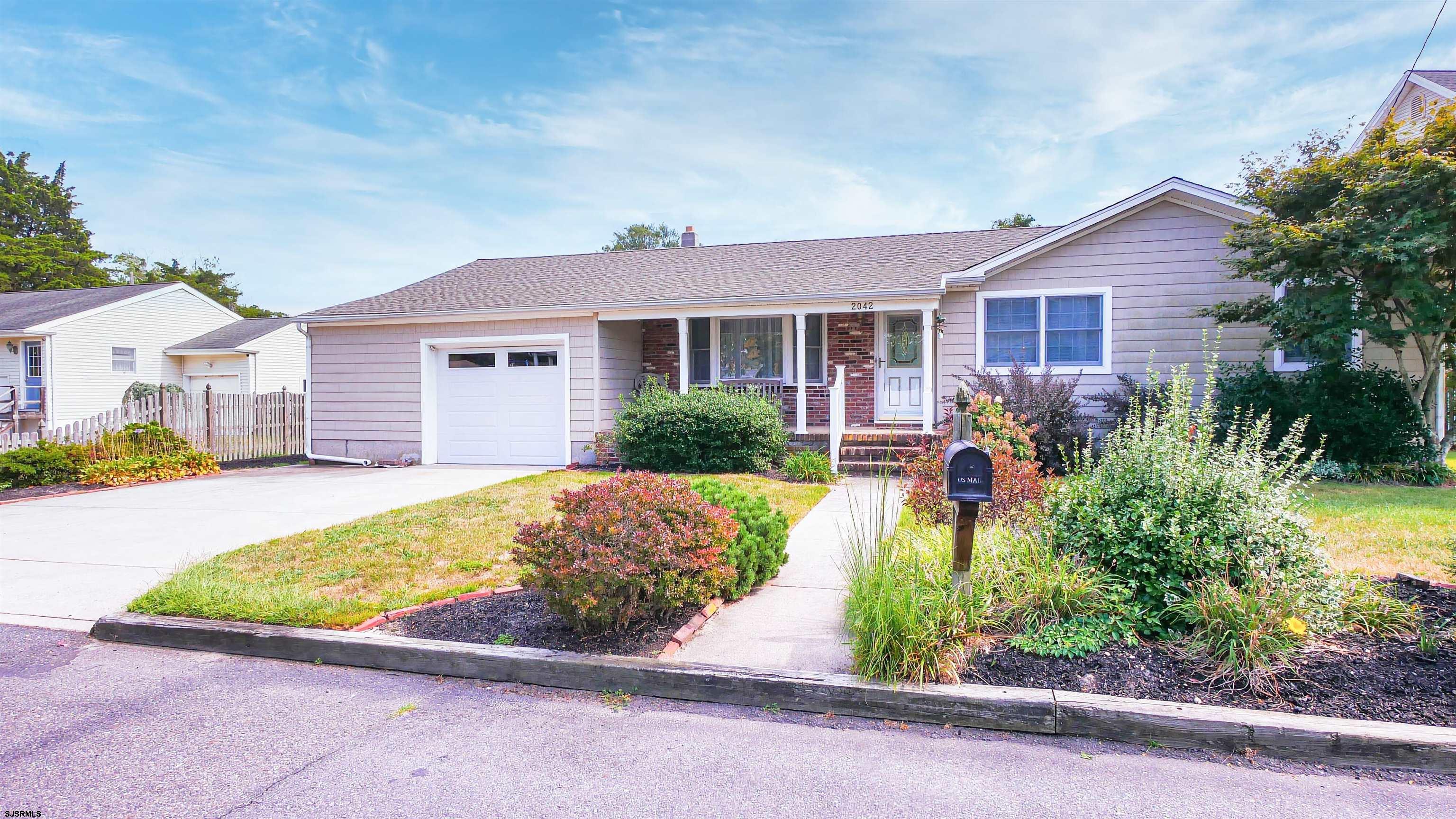 a view of a house with a yard and plants