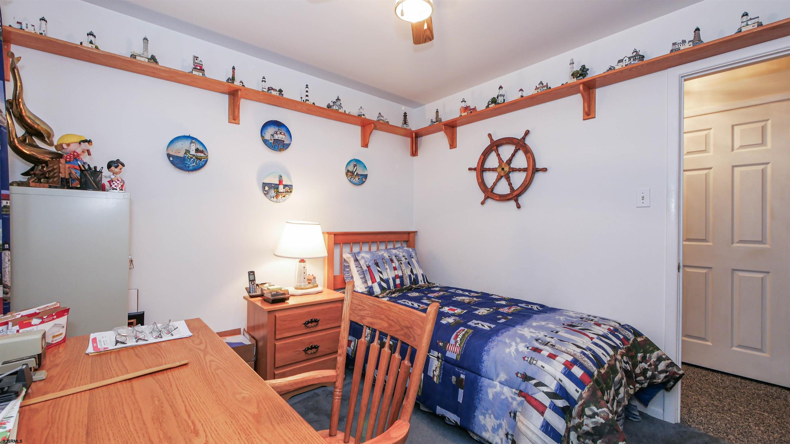 2042 Sutton Avenue Northfield, NJ 08225 - Photo 21 of 32 a bedroom with a bed and a dresser