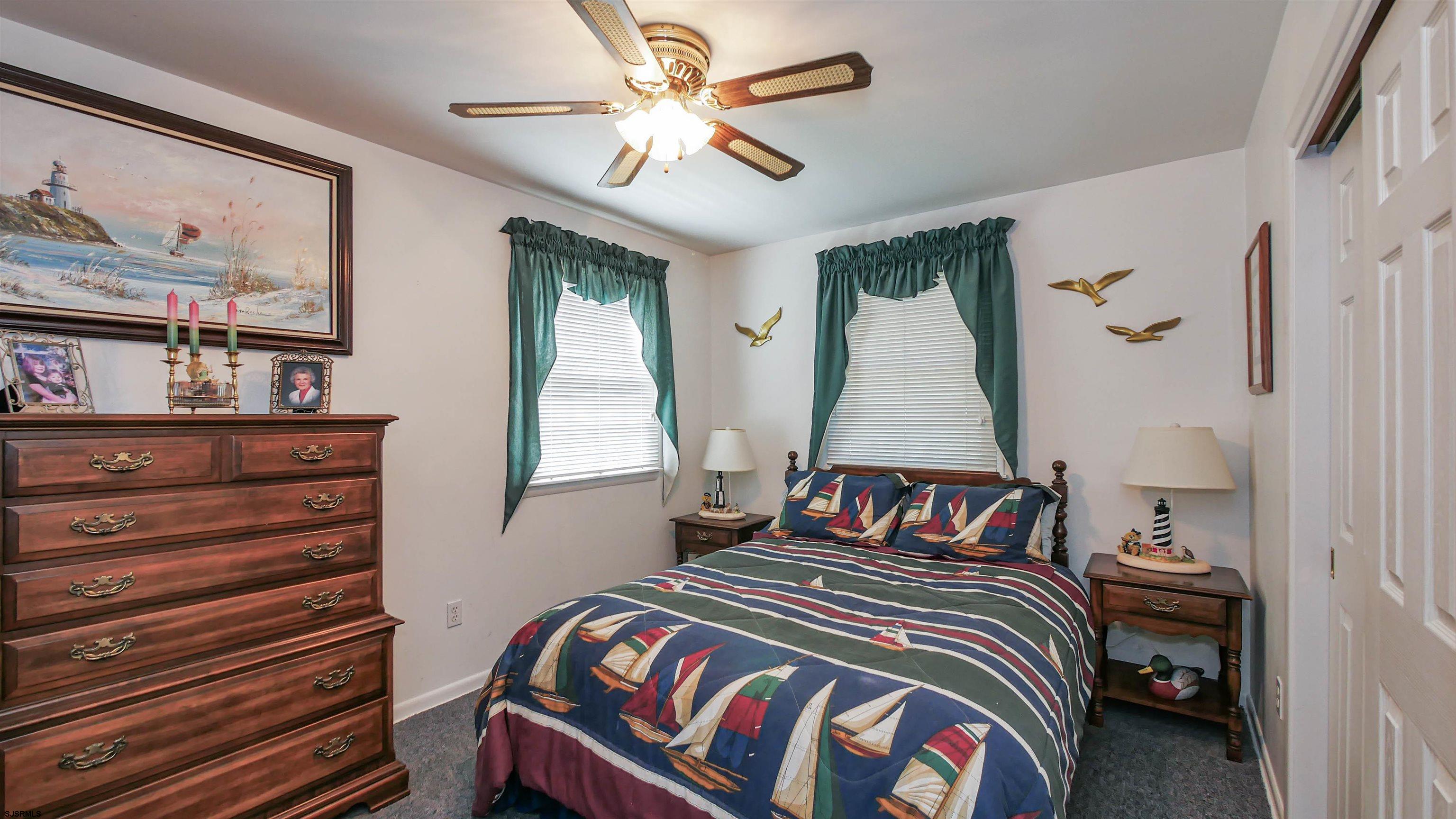 2042 Sutton Avenue Northfield, NJ 08225 - Photo 22 of 32 a bedroom with a bed and a painting on the wall
