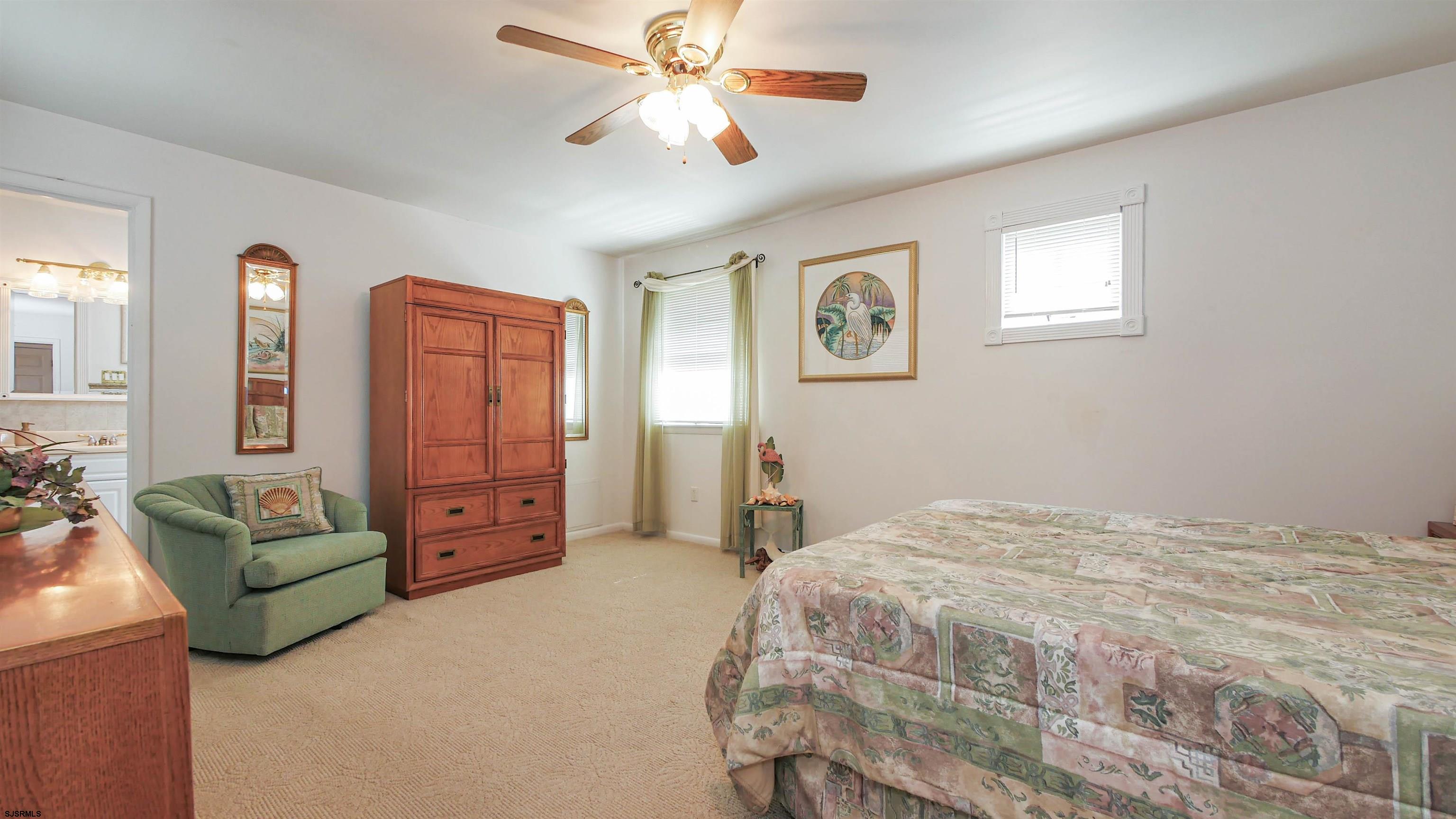 2042 Sutton Avenue Northfield, NJ 08225 - Photo 24 of 32 a bedroom with a bed couch and window