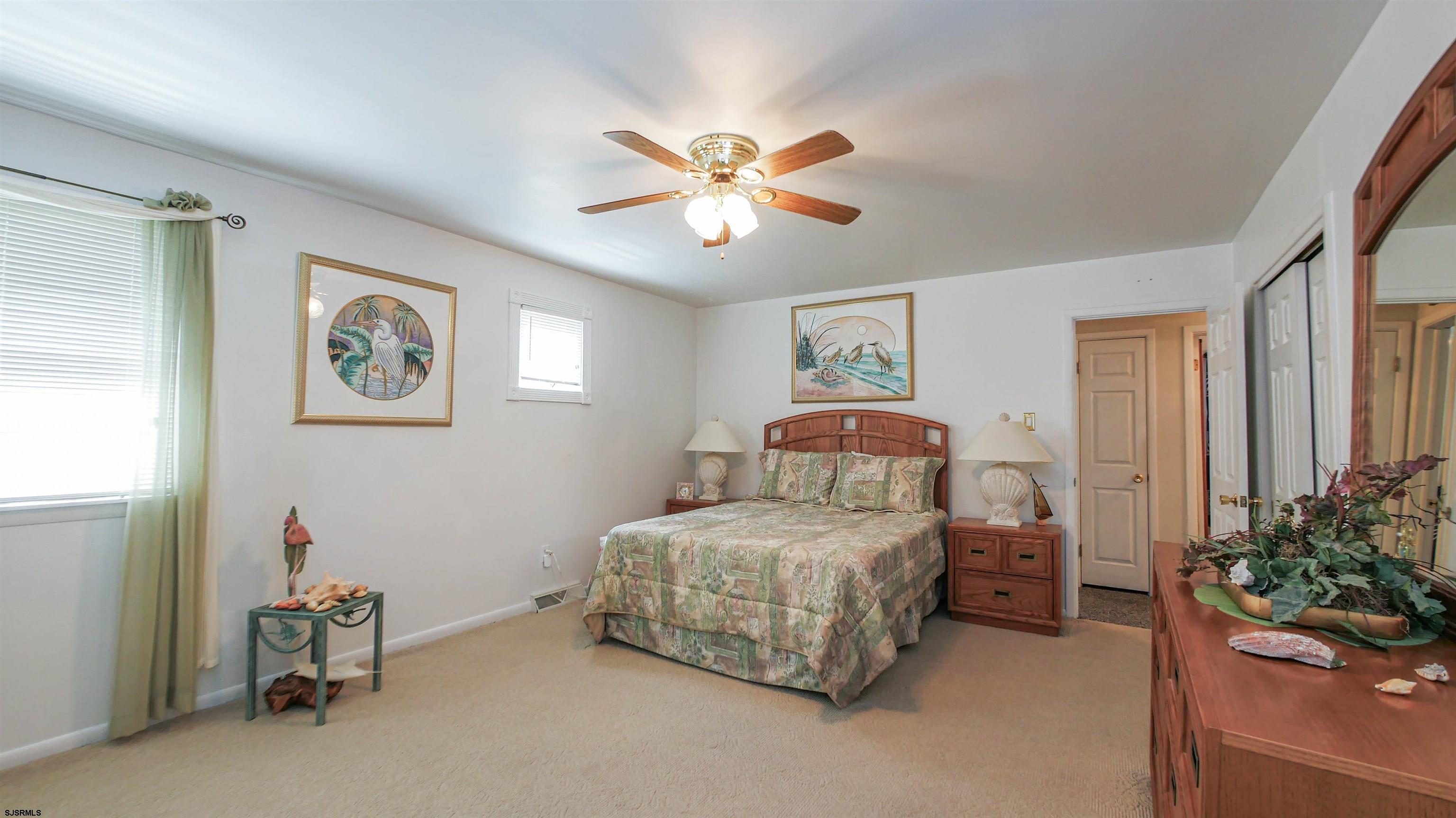 2042 Sutton Avenue Northfield, NJ 08225 - Photo 25 of 32 a bedroom with a bed and a chandelier