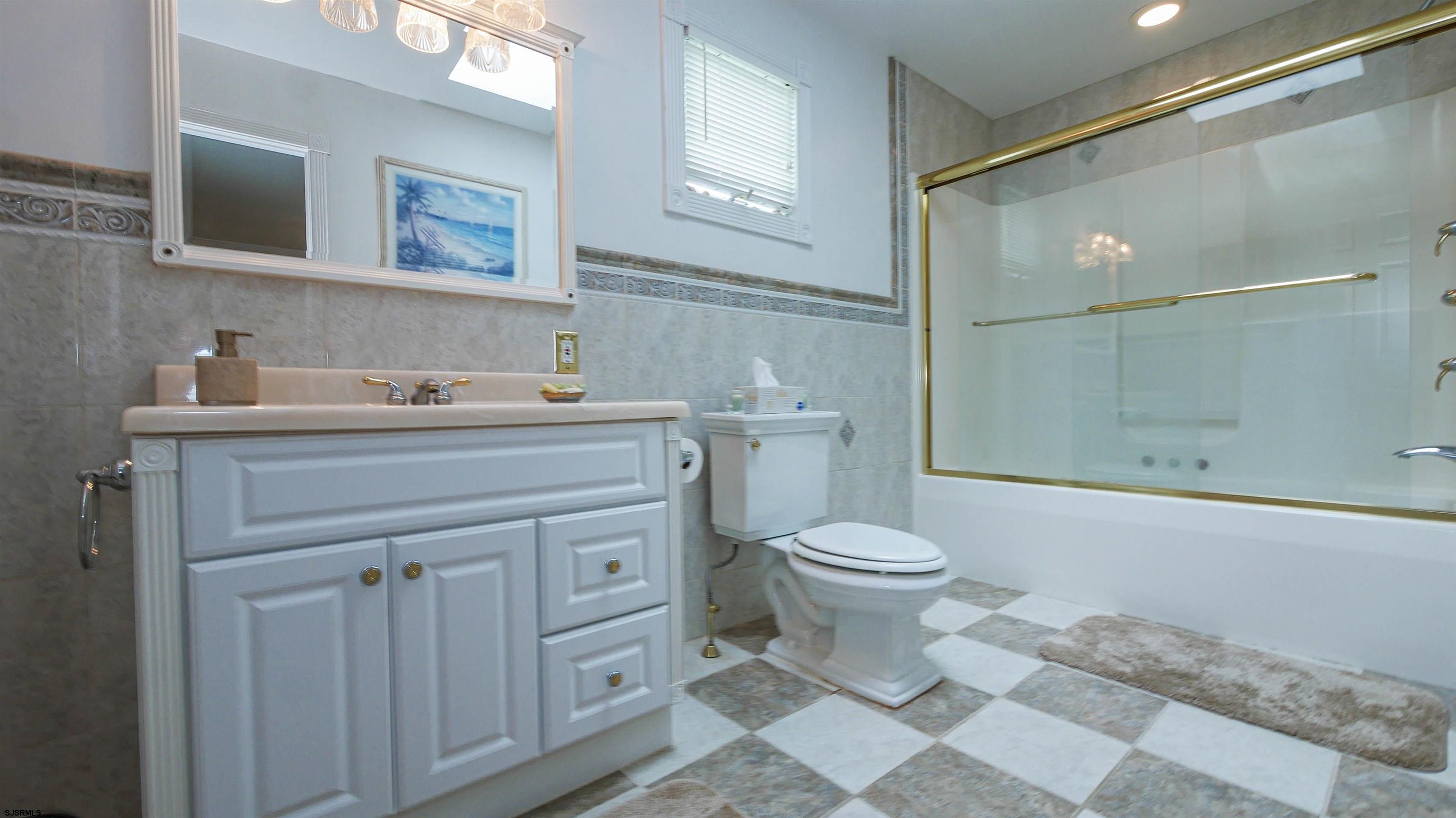 2042 Sutton Avenue Northfield, NJ 08225 - Photo 26 of 32 a bathroom with a sink a toilet and shower