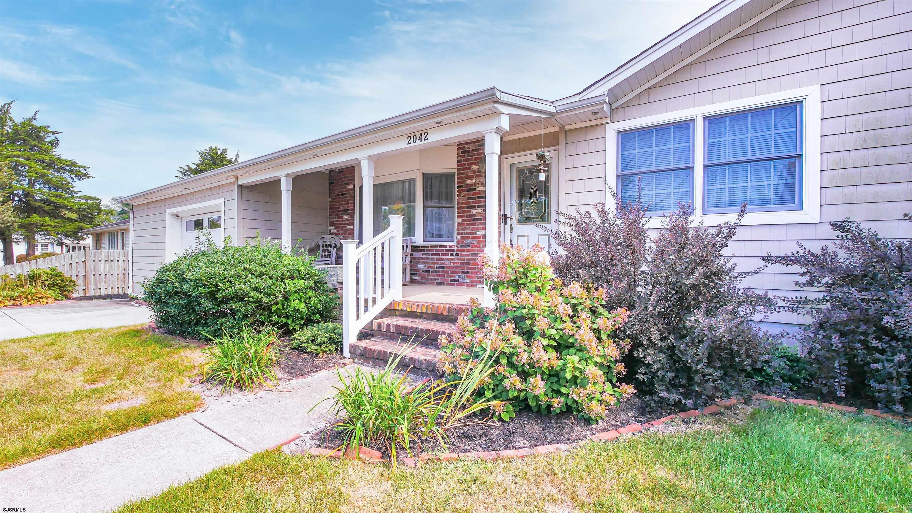 2042 Sutton Avenue Northfield, NJ 08225 - Photo 3 of 32 a front view of a house with garden