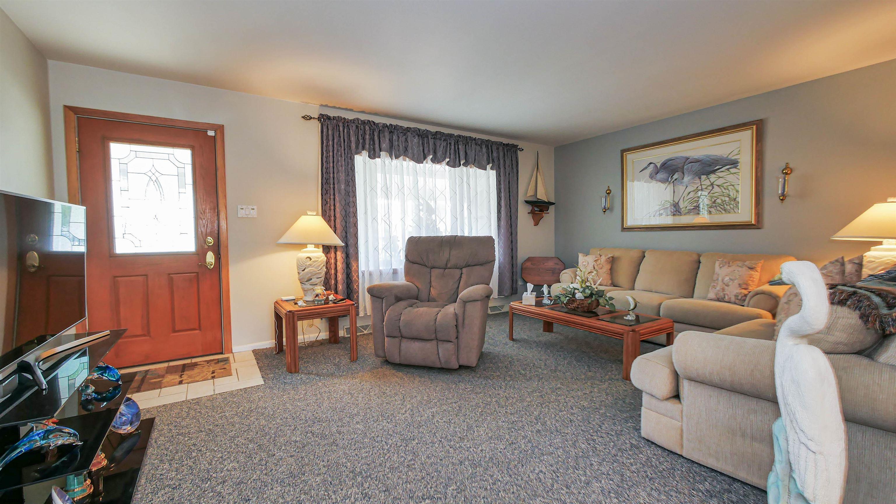 2042 Sutton Avenue Northfield, NJ 08225 - Photo 8 of 32 a living room with furniture and a flat screen tv