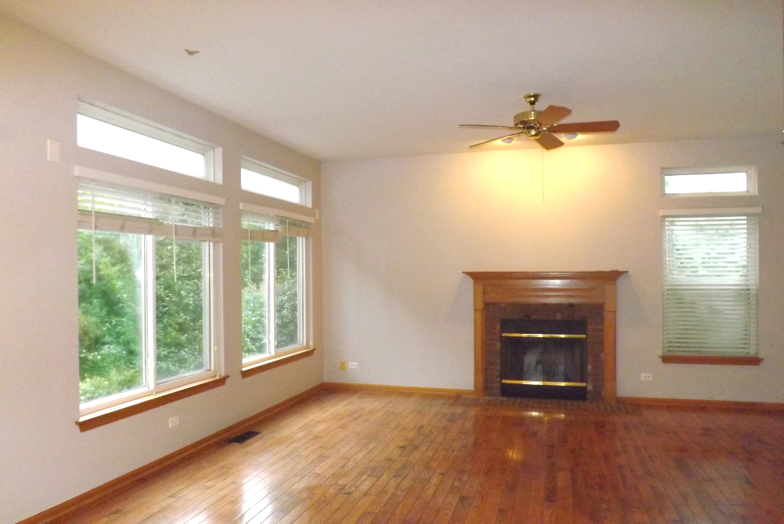 512 West Wildspring Road Round Lake, IL 60073 - Photo 5 of 16 a view of an empty room with a window and wooden floor