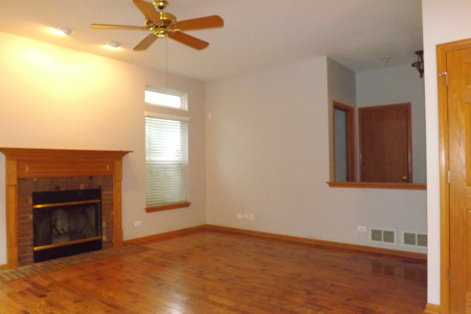 512 West Wildspring Road Round Lake, IL 60073 - Photo 6 of 16 a view of empty room with wooden floor and fan
