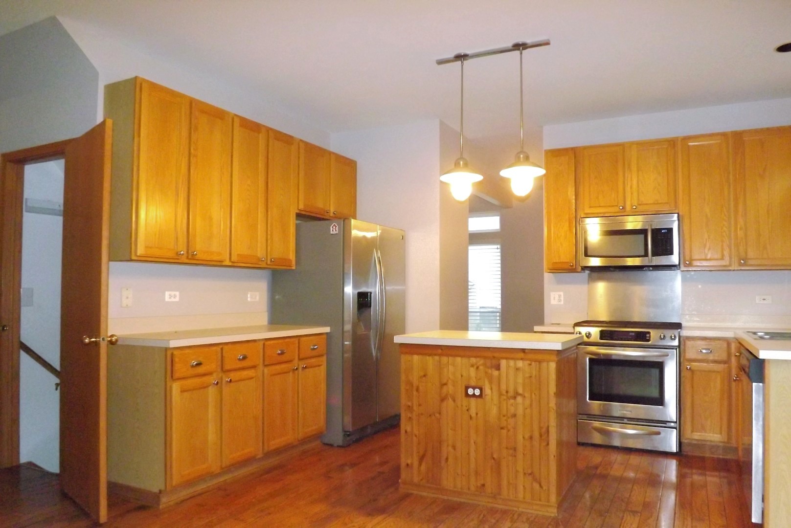 512 West Wildspring Road Round Lake, IL 60073 - Photo 7 of 16 a kitchen with stainless steel appliances granite countertop a stove a sink and a refrigerator