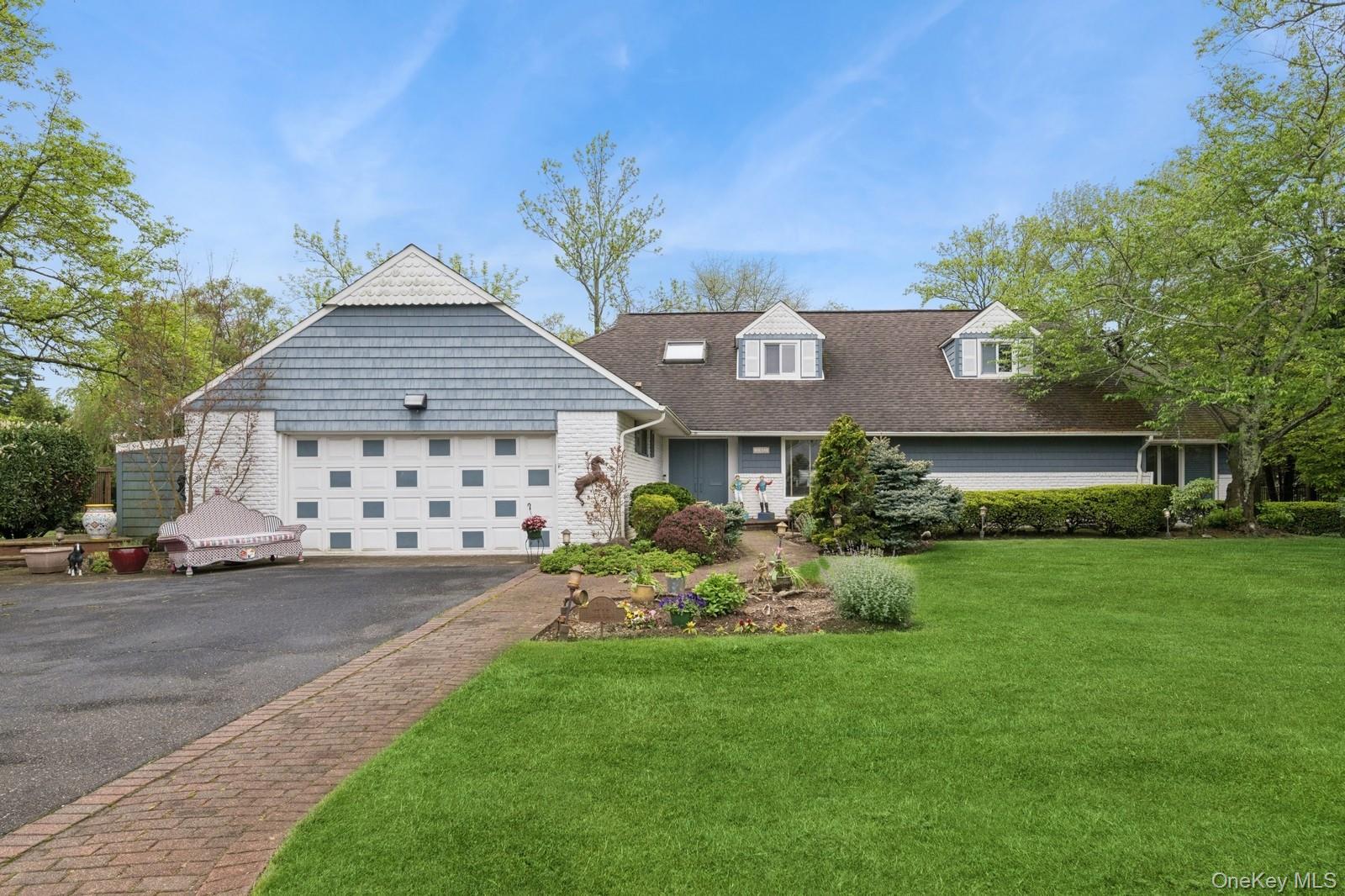 a front view of a house with a garden and porch