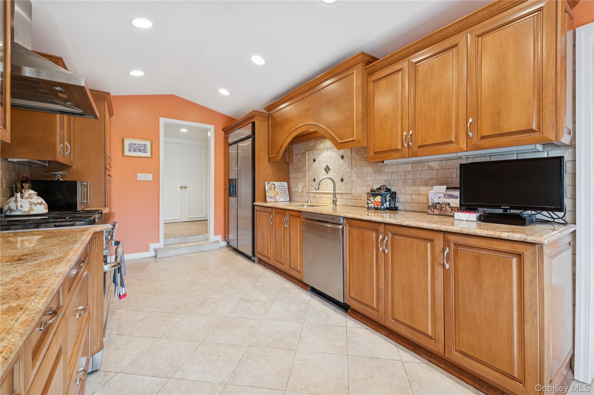 1302 Azure Place Hewlett, NY 11557 - Photo 13 of 32 a kitchen with stainless steel appliances granite countertop a sink and cabinets