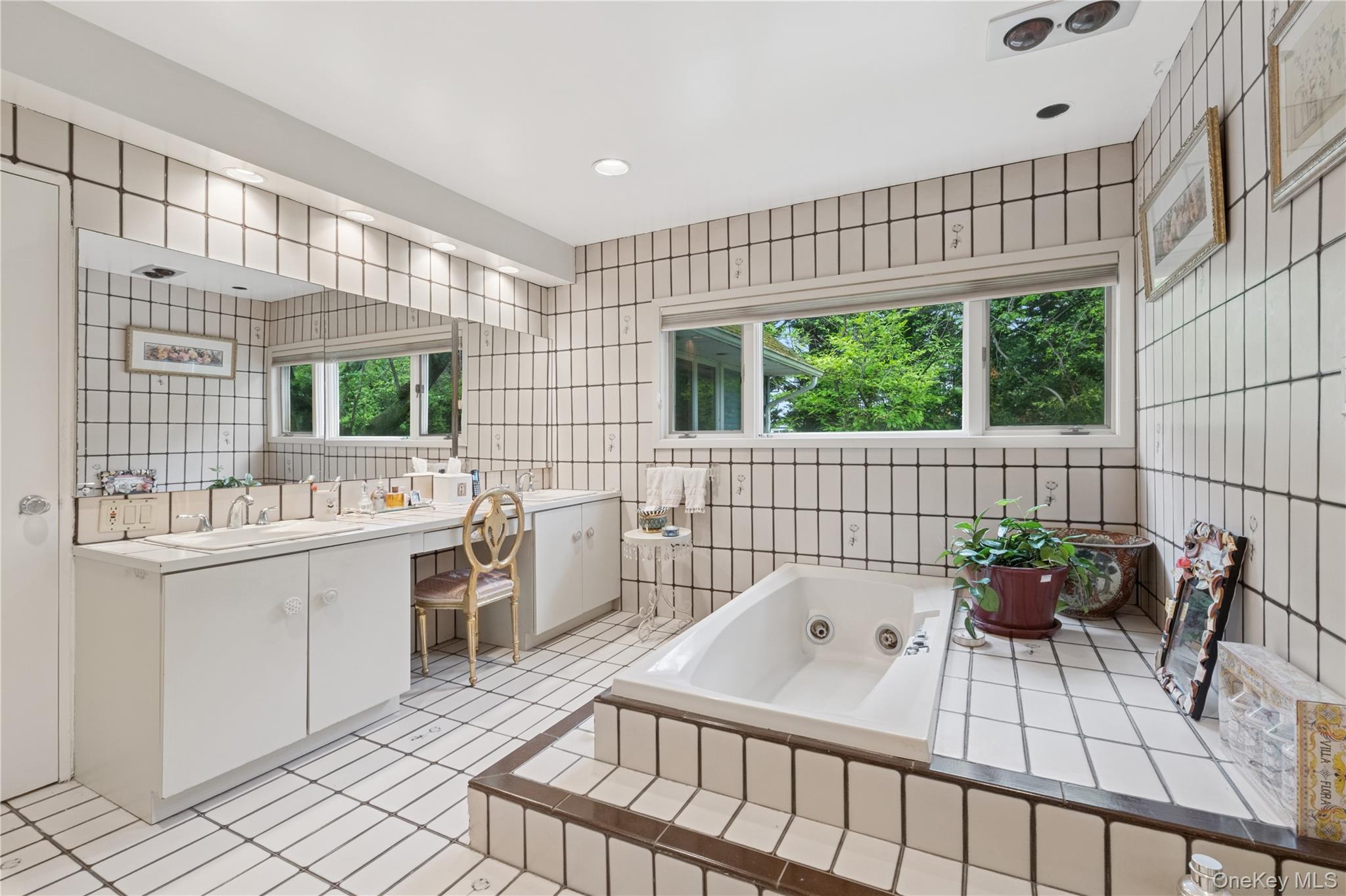 1302 Azure Place Hewlett, NY 11557 - Photo 19 of 32 a bathroom with a sink a bathtub and next to a window