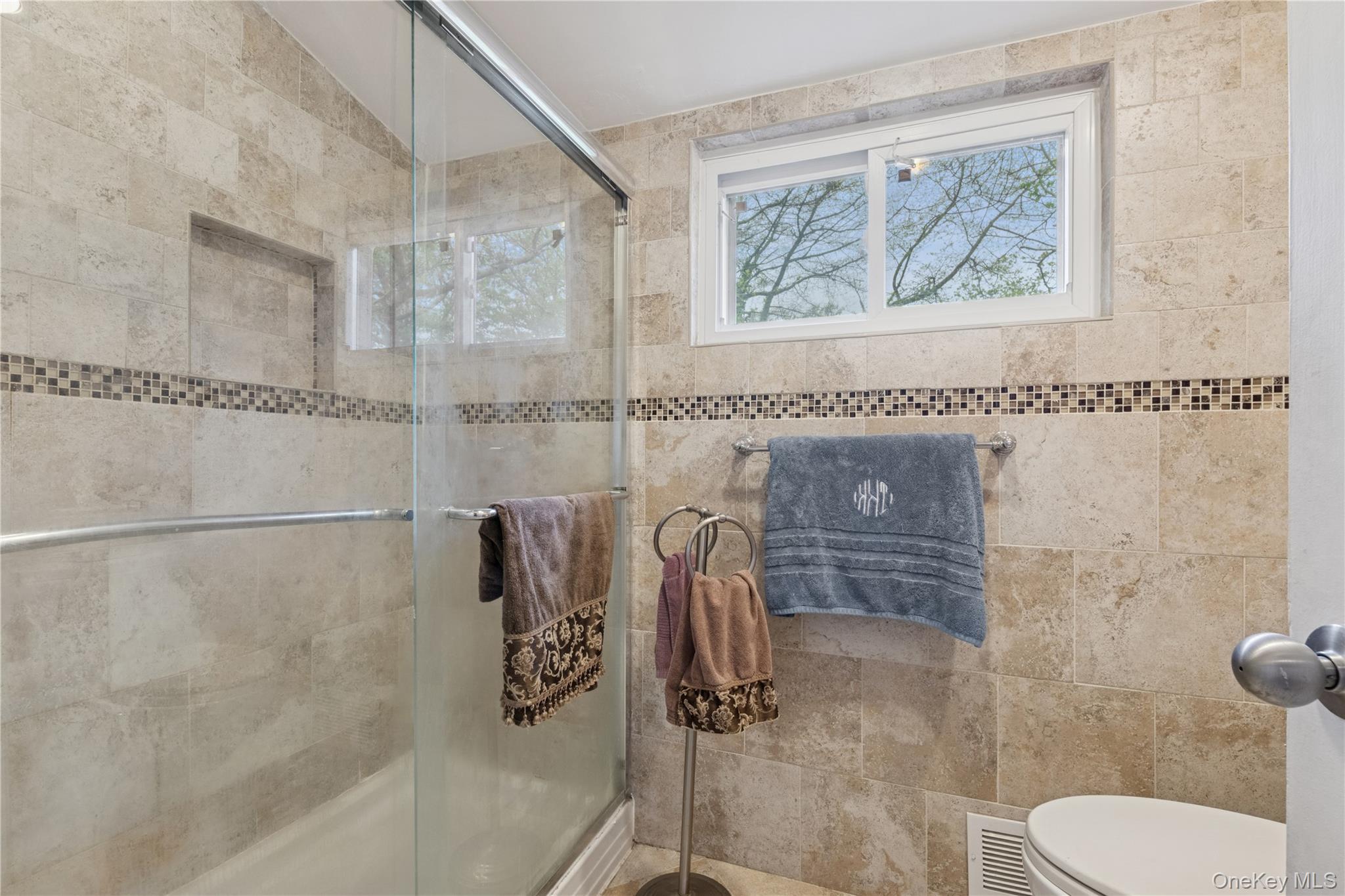 1302 Azure Place Hewlett, NY 11557 - Photo 22 of 32 a bathroom with a shower and toilet
