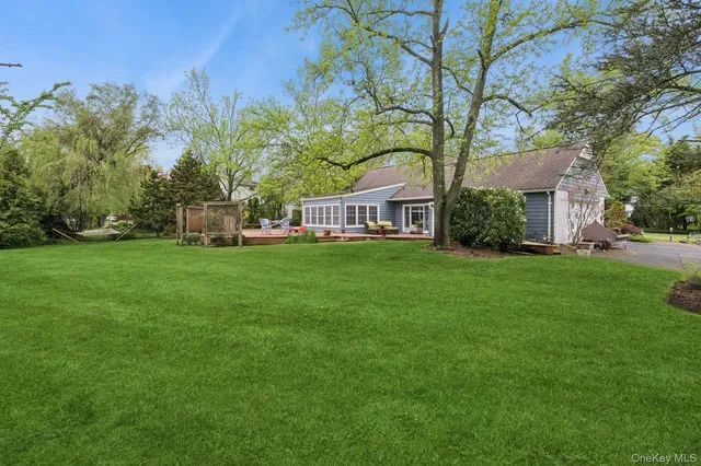 a view of a house with a yard and sitting area