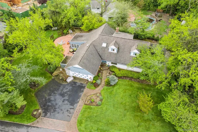 an aerial view of a house with a yard