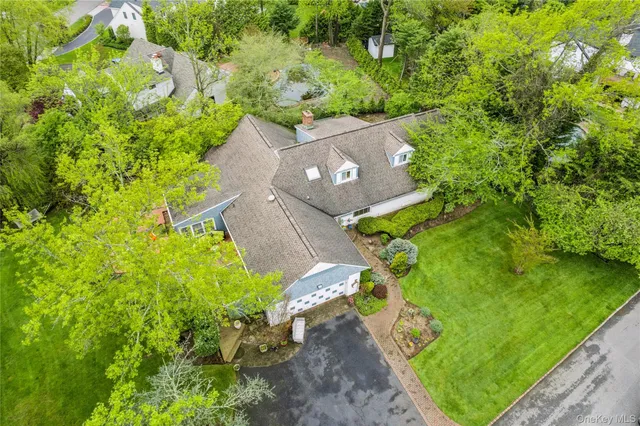 an aerial view of a house with a yard basket ball court