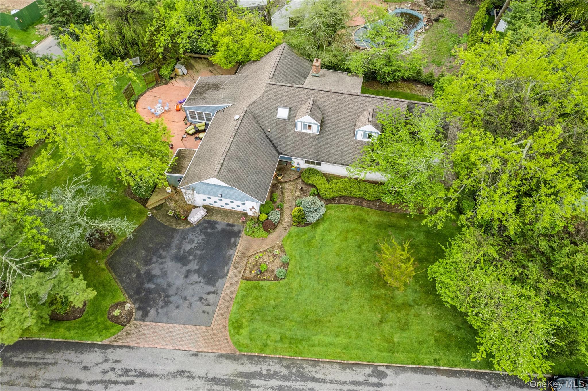 1302 Azure Place Hewlett, NY 11557 - Photo 4 of 32 an aerial view of a house with a garden