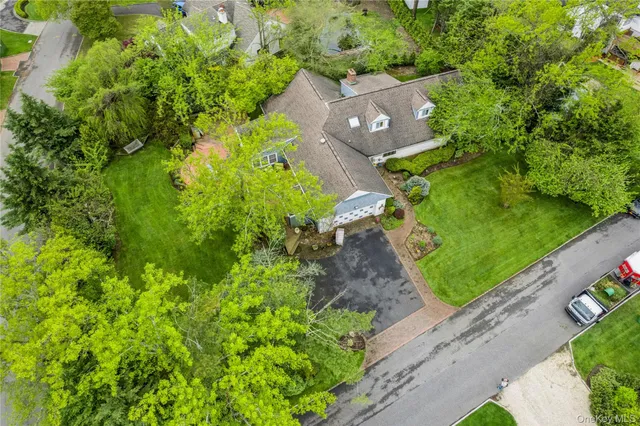 an aerial view of a house with a yard