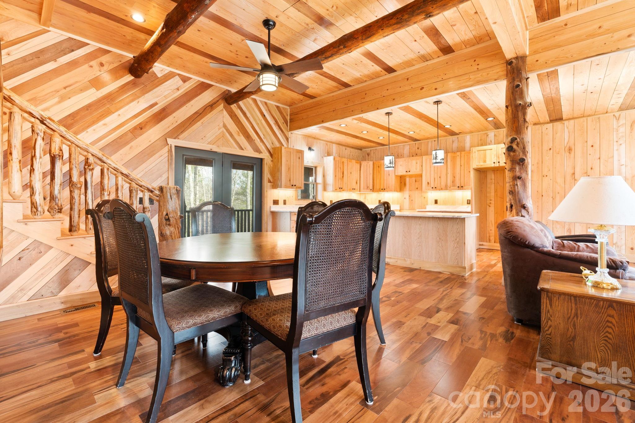 449 Hampton Ridge Road Fleetwood, NC 28626 - Photo 16 of 48 a dining room with furniture a chandelier and wooden floor