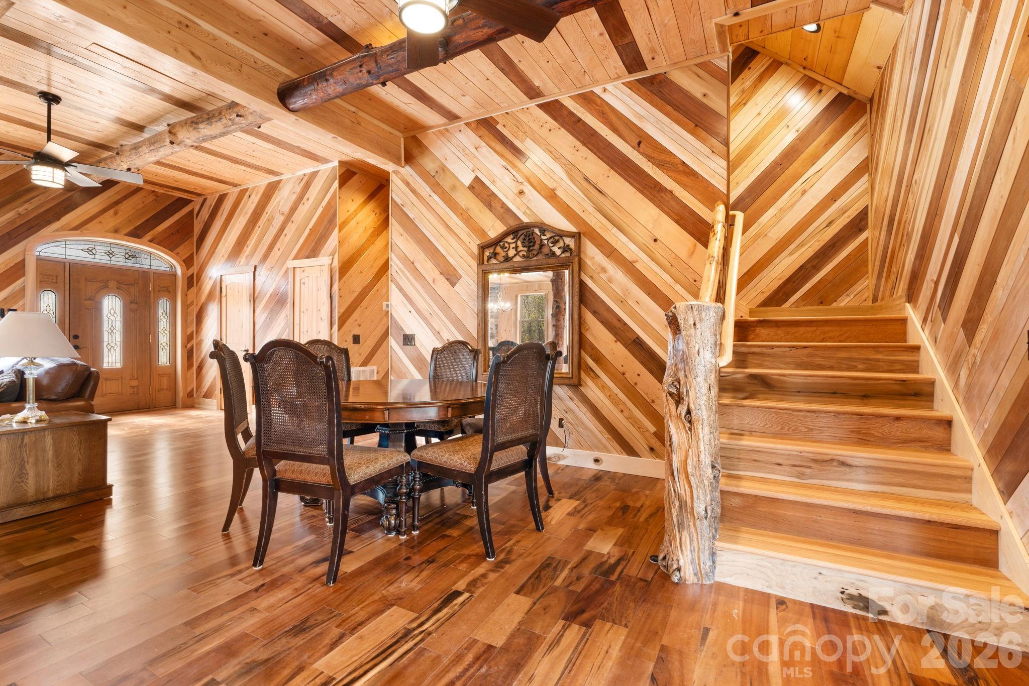 449 Hampton Ridge Road Fleetwood, NC 28626 - Photo 22 of 48 a view of a patio with table and chairs and wooden floor