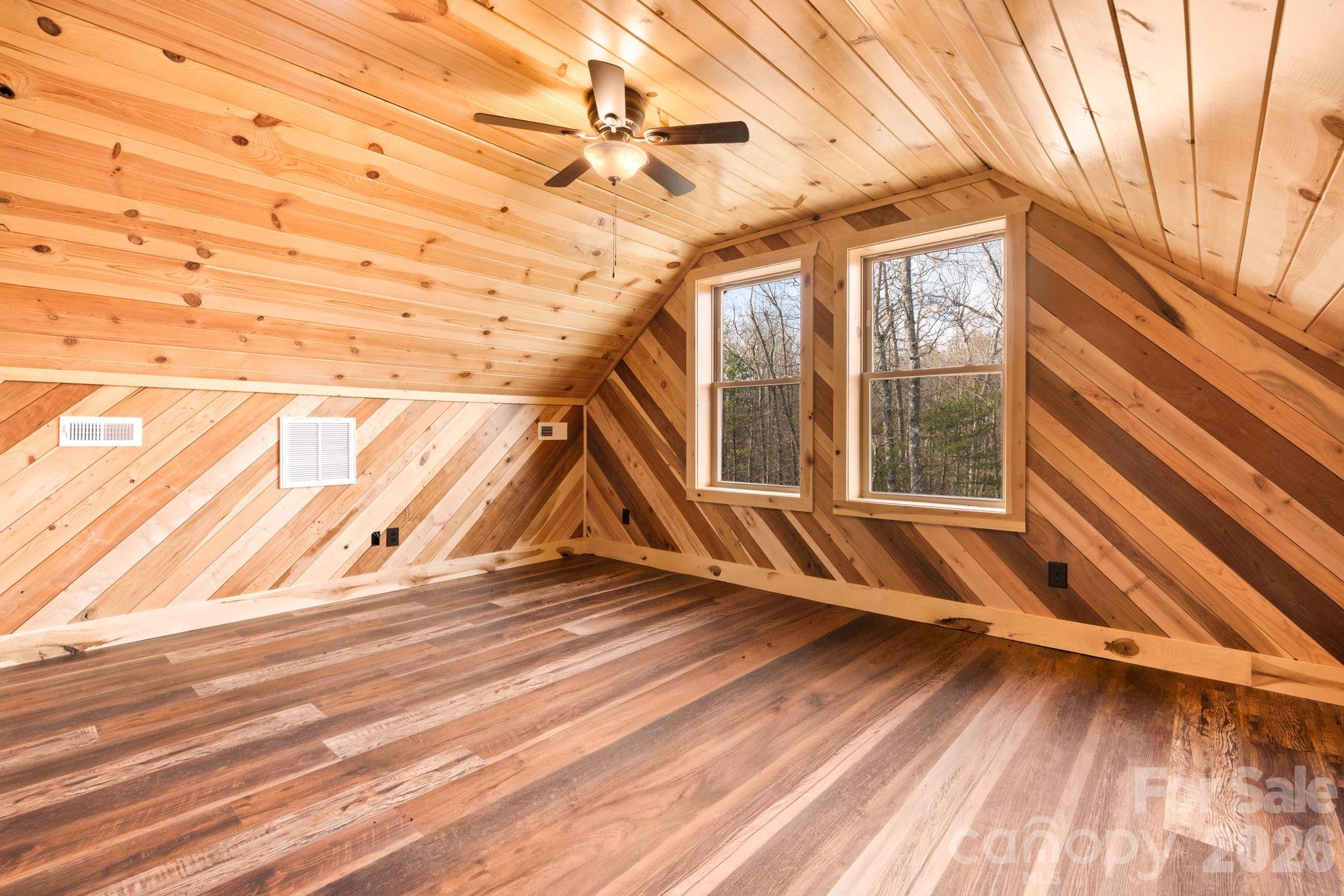 449 Hampton Ridge Road Fleetwood, NC 28626 - Photo 23 of 48 a view of an empty room with wooden floor and a window