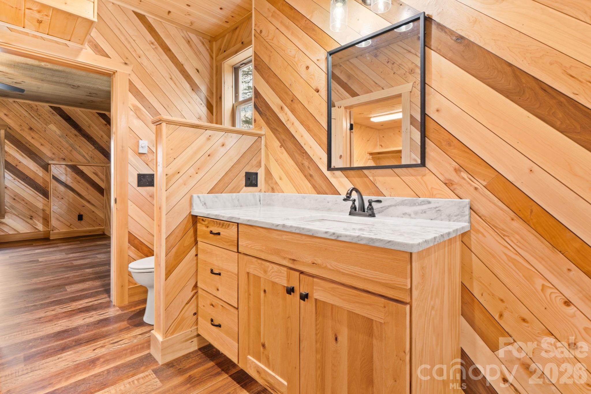 449 Hampton Ridge Road Fleetwood, NC 28626 - Photo 24 of 48 a bathroom with a sink and a mirror