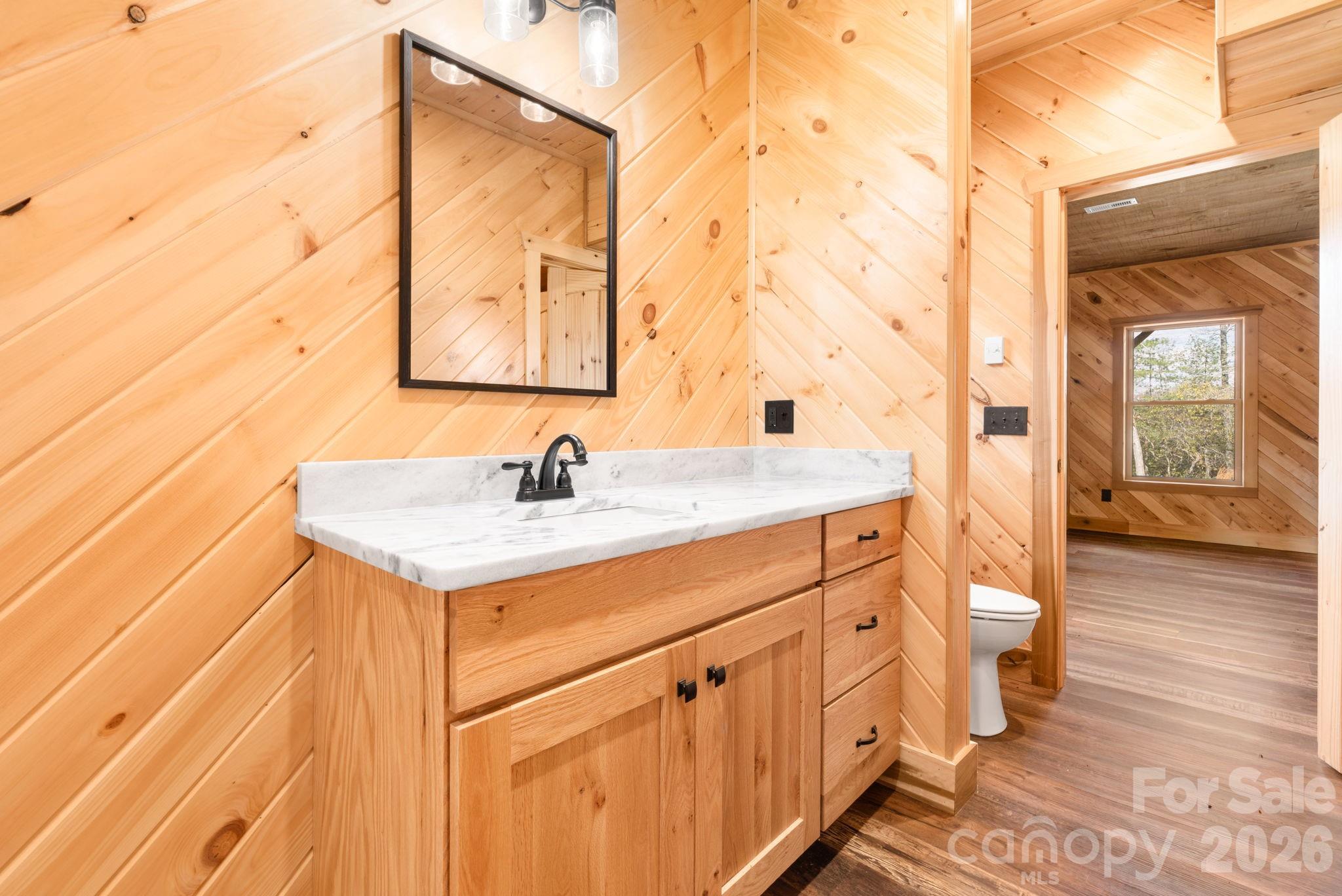 449 Hampton Ridge Road Fleetwood, NC 28626 - Photo 42 of 48 a bathroom with a sink and a mirror