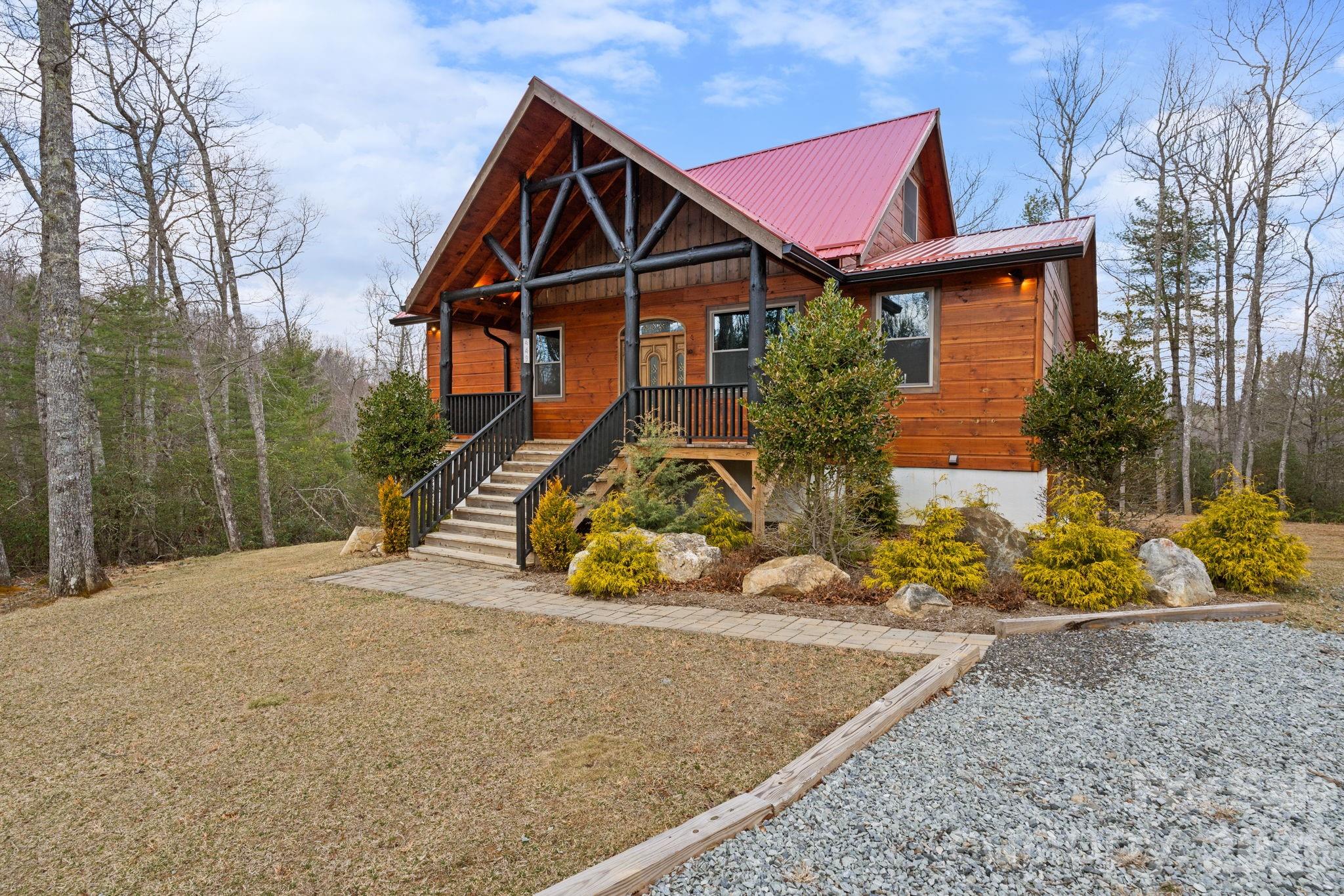 449 Hampton Ridge Road Fleetwood, NC 28626 - Photo 45 of 48 a front view of a house with a yard