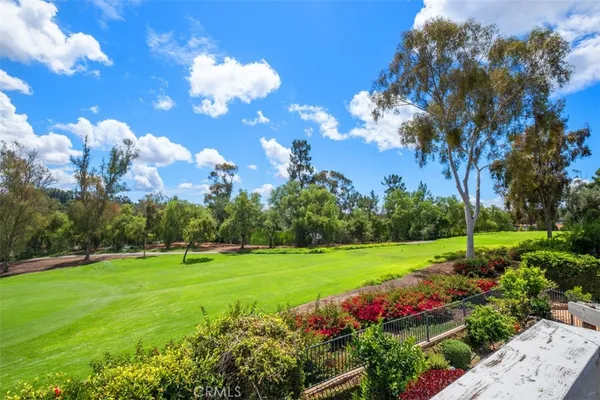 a view of a building with a big yard and potted plants